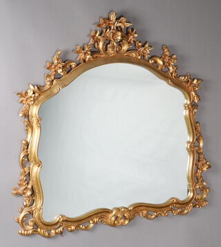 A Rococo style shaped mirror contained in a pierced gilt resin frame 116cm x 121cm 