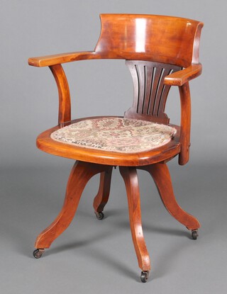 An Edwardian bleached beech bar back revolving office chair, upholstered in tapestry material 81cm h 