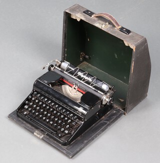 An Olympia Elite portable manual typewriter with carrying case 