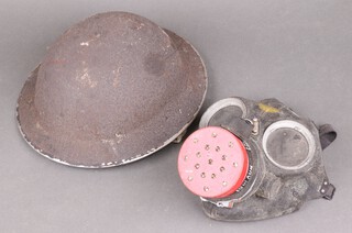 A Siebe gas mask together with a steel helmet 