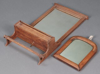 An Edwardian rectangular plate wall mirror contained in a walnut frame, the base incorporating a box and towel rail 69cm h x 37cm x 15cm together with a Victorian arched plate mirror contained in a mahogany frame 30cm x 24cm 