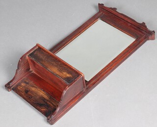 An Edwardian rectangular bevelled plate mirror contained in an oak frame, the base fitted a box with hinged lid 70cm x 36cm