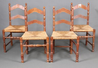 A set of 4 elm ladder back dining chairs with woven rush seats (1 with damaged stretcher) 