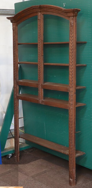 An 18th Century Continental carved oak, arch shaped, armoire frame converted for use as a 5 tier bookcase 212cm h x 130cm w x 23cm d 