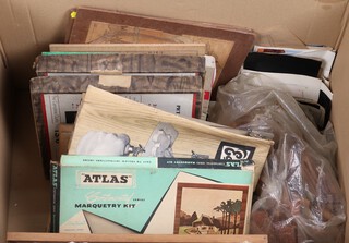 A collection of Atlas marquetry and veneer kits and patents, contained in a cardboard box 