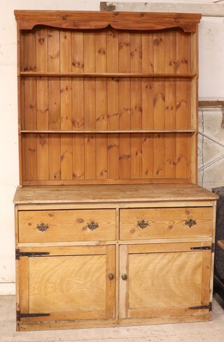 A Victorian pine dresser with later raised back moulded cornice, the base fitted 2 drawers above double cupboard 220cm h x 138cm w x 58cm d 