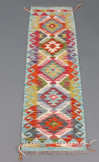 A white, orange and green ground Chobi Kilim runner 150cm x 41cm 