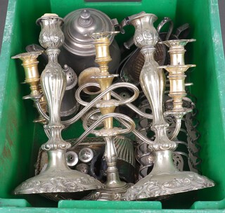A pair of embossed silver plated candlesticks, a 3 light candelabrum, a 7 bar toast rack, sugar bowl and cream jug and other plated items 