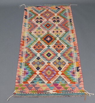 A white, green and tan ground Chobi Kilim runner 161cm x 72cm with all over geometric design 