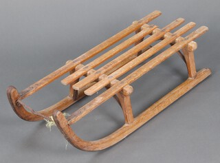 Davos, a slatted toboggan 20cm h x 92cm l x 34cm w (1 slat is damaged) 