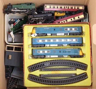 A Triang Dublo double headed diesel locomotive and carriage, a R150 locomotive, a Triang R59 tank engine unboxed and a collection of various unboxed carriages, rolling stock and plastic buildings, all contained in a cardboard box  