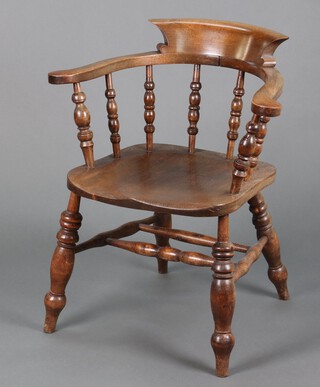 A 20th Century elm and beech smokers bow chair with solid seat and bobbin turned decoration, raised on turned supports 81cm h x 68cm w x 48cm d  