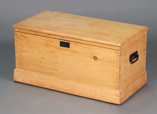 A 19th Century pine trunk with hinged lid and iron drop handles, the interior fitted a tray 43cm h x 82cm w x 42cm d 