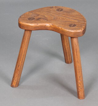 An elm kidney shaped 3 legged stool on outswept supports 33cm h x 33cm w x 23cm d 