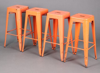 Four orange painted pressed metal stacking stools 77cm h x 30cm w x 30cm d 
