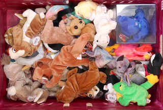 A collection of TY Beanie Babies bears contained in a purple plastic box 