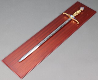 A Wilkinson Sword "The Millennium Sword" no.0036 109cm l, on a wooden mount