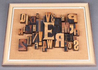 An abstract picture of letters and numbers formed from printers blocks, framed 40cm x 51cm 