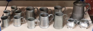 A 19th Century Continental lidded pewter tankard, a planished pewter sugar bowl and cream jug and 11 pewter tankards  