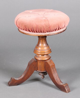 A Victorian walnut circular stool with upholstered seat 