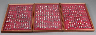 A large collection of souvenir spoons contained in 3 mahogany display cabinets  