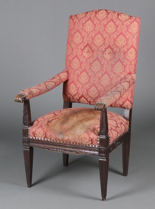 A Continental oak open arm chair, upholstered in red floral material, raised on square tapered supports 117cm h x 65cm w x 64cm d  (stain to seat) 