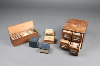A large collection of 1920's and 30's photographic slides depicting landscapes of France, Sussex/Surrey and Devon together with boxes of unused plates, a quantity of slides contained in a 4 drawer index card filing cabinet 