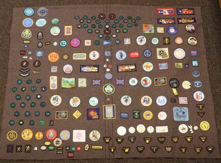 Of Girl Guide interest, a Girl Guide blanket with numerous badges, mostly from the 1980's and early 90's 105cm x 135cm 