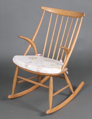 An elm and beech Ercol style stick and rail back rocking chair 88cm h x 57cm w x 74cm d (sun bleached) 