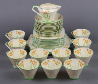 A 37 piece Art Deco Salon (floral) patterned tea service comprising 2 bread plates, 11 tea plates (3 cracked), milk jug, 12 saucers (1 cracked), 11 cups (5 cracked) together with a Sylvac pottery jug with squirrel handle, a Crown Staffordshire part coffee set and a Swansea Ware jug 