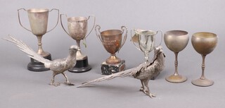 Two silver plated table ornaments in the form of pheasants, 4 twin handled trophy cups and 2 goblet shaped ditto 