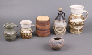 An Art Pottery jug 25cm, 3 other Art Pottery jugs, ditto ewer and cover, cookie jar and cover and a vase 