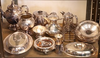 An oval silver plated entree dish and cover, an embossed coffee pot, twin handled sugar bowl, tea strainer and other items of silver plate