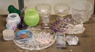 A green glass paperweight in the form of a bird 9cm, a green Art Glass vase 9cm, a moulded glass vase decorated buildings and figures and a small collection of decorative glassware  