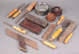 Two 19th Century mahogany fishing reels, 2 oil stones, a large lens and a collection of chisels 