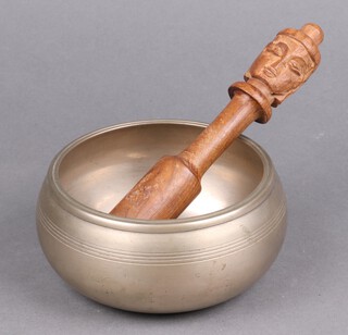 An Eastern bronze "singing" bowl 7cm x 13cm 