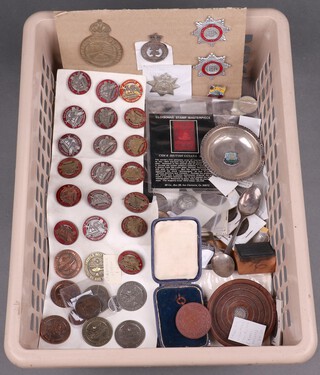 A collection of badges and coins 