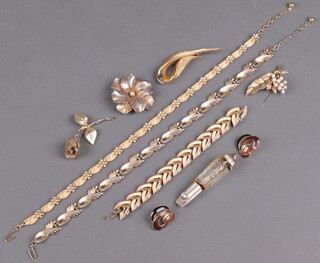 A Sphinx gilt ribbon brooch, a Trifari gilt metal brooch, an Exquisite gilt metal brooch and a collection of gilt metal costume jewellery 