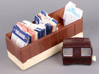A brown Bakelite view master together with various cassettes