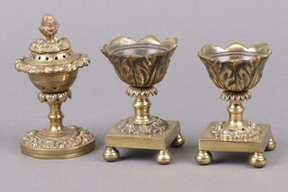A Regency pierced gilt metal circular pot pourri and cover on a circular spreading base, together with a pair of flowers head ditto raised on square bases with bun feet 11cm (both missing lids) 