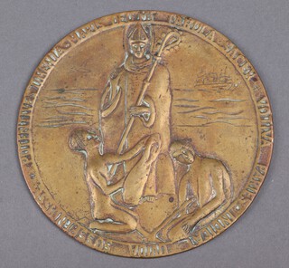 A circular bronze plaque decorated a Saint 16cm 