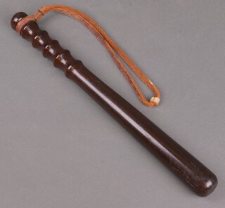 A turned wooden police truncheon 