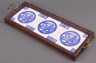 A St Dunstan's rectangular twin handled tea tray with carved oak frame, the centre with 3 blue and white Willow pattern tiles 18cm x 49cm 