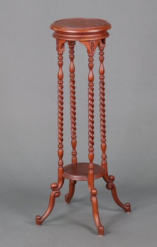A Victorian style circular 2 tier jardiniere stand, raised on spiral turned supports with undertier 100cm x 28cm diam.