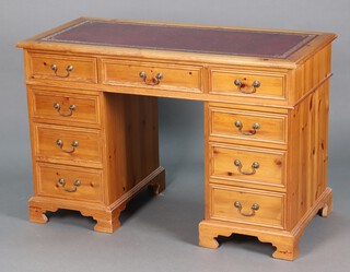 A Victorian style pine kneehole desk with red leather inset writing surface fitted 9 drawers, 78cm h x 120cm w x 57cm d 