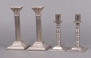 A pair of reeded silver plated candlesticks with Corinthian capitals 20cm and a pair of polished metal candlesticks 17cm 