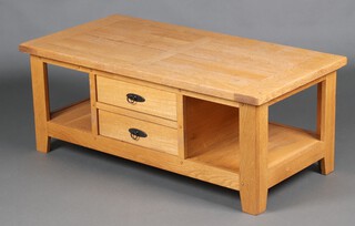 A rectangular light oak coffee table the centre fitted 2 drawers flanked by recesses 48cm h x 119cm w x 60cm (water, sun bleached and contact marks in places)  