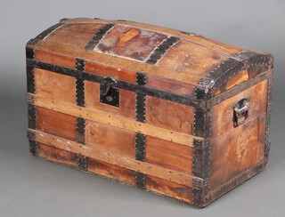 A Victorian wooden and metal bound dome shaped cabin trunk with iron drop handles 50cm h x 94cm w x 51cm d 