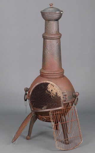 A cast iron chiminea with griddles, etc 123cm h 