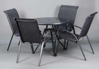 A black metal framed folding garden table with glass top 71cm h x 77cm diam. together with 4 tubular metal and woven canvas garden armchairs 